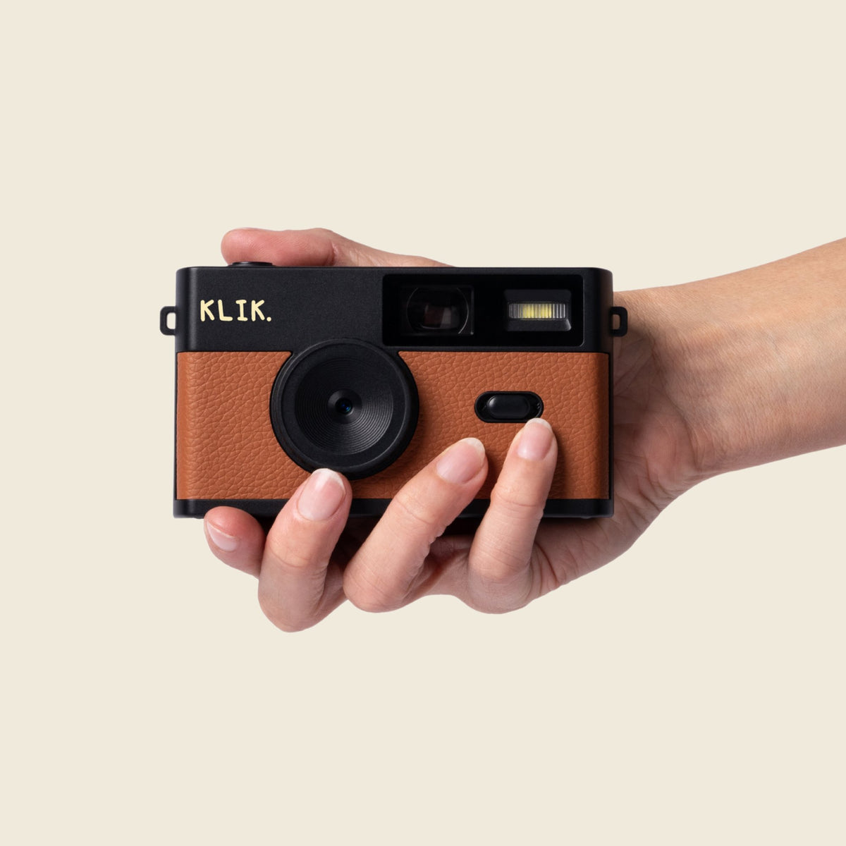 Brown KLIK camera in hand